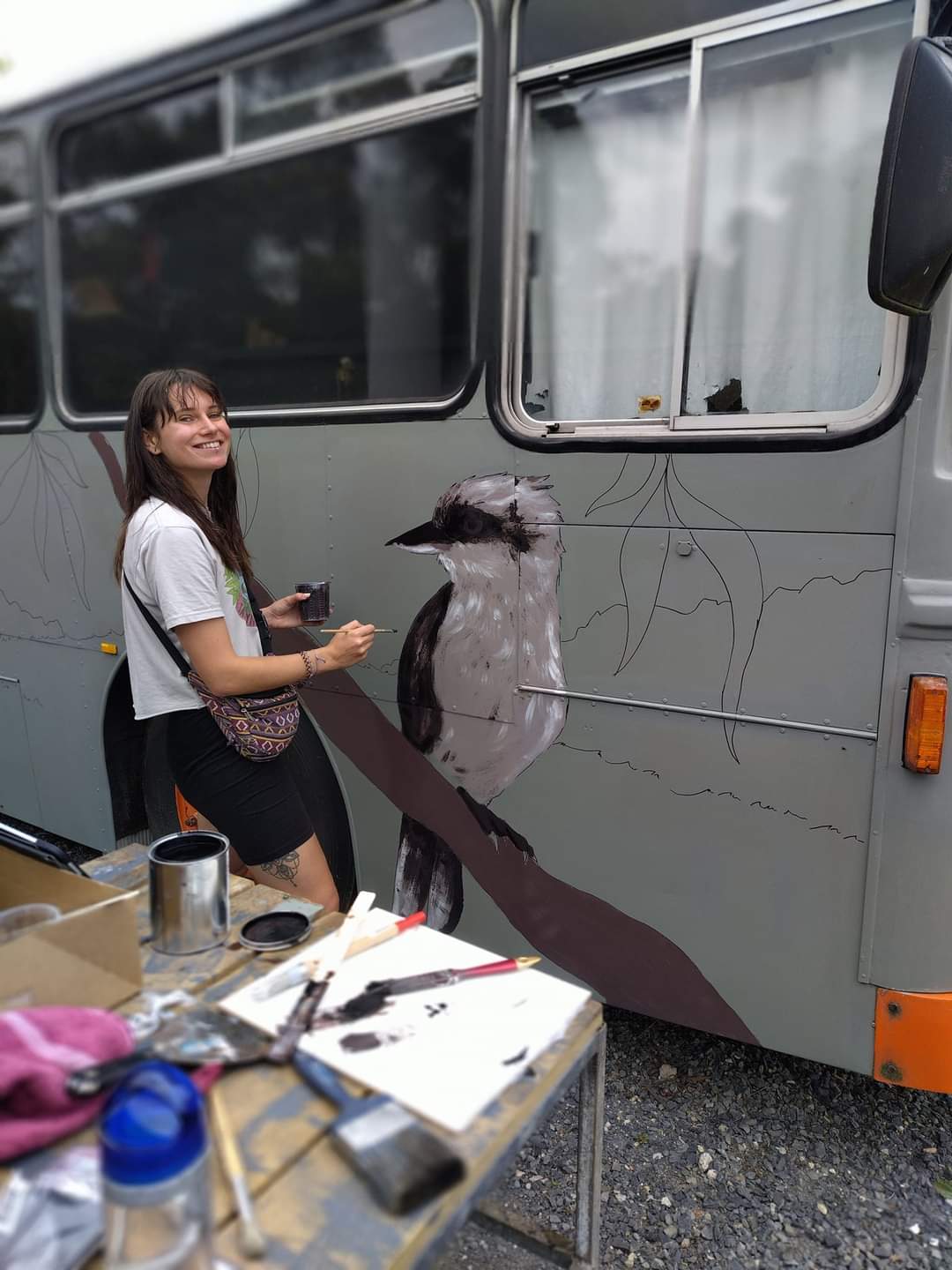 Laura Vogel Designer and Illustrator painting a mural art of a bird on a bus in Australia, Melbourne